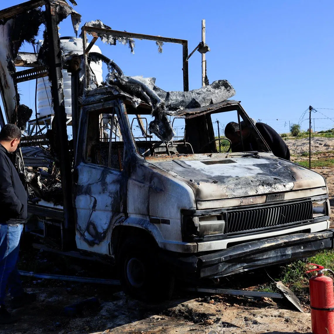 Palestinians check damage to a burned vehicle, which Palestinians say was damaged by Israeli settlers, in Susiya near Hebron in the Israeli-occupied West Bank February 25, 2026. REUTERS/Mussa Qawasma