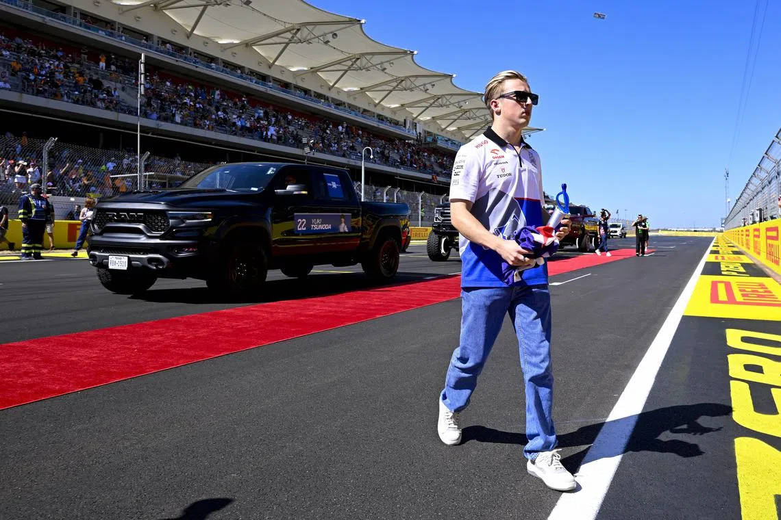 Oct 20, 2024; Austin, Texas, USA; Visa Cash App RB Formula One Team driver Liam Lawson (30) of Team New Zealand walks back to the paddock after the driver’s parade before the 2024 Formula One US Grand Prix at Circuit of the Americas. Mandatory Credit: Jerome Miron-Imagn Images