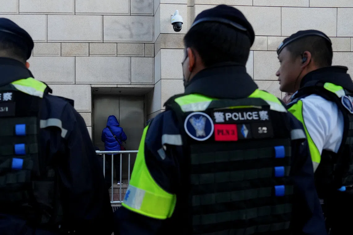 People queue outside the West Kowloon Magistrates' Courts building for the verdict in the national security collusion trial of Jimmy Lai, founder of the now-defunct pro-democracy newspaper Apple Daily, in Hong Kong, China, December 15, 2025. REUTERS/Lam Yik