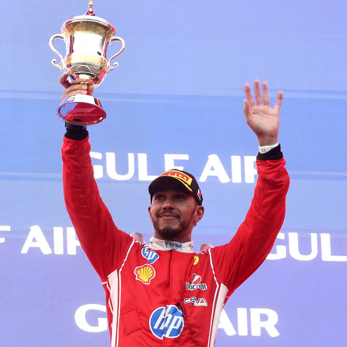 Formula One F1 - Bahrain Grand Prix - Sepang International Circuit, Sepang, Malaysia - October 4, 2026 Ferrari's Lewis Hamilton celebrates with his trophy on the podium after finishing third in the Bahrain Grand Prix REUTERS/Jakub Porzycki