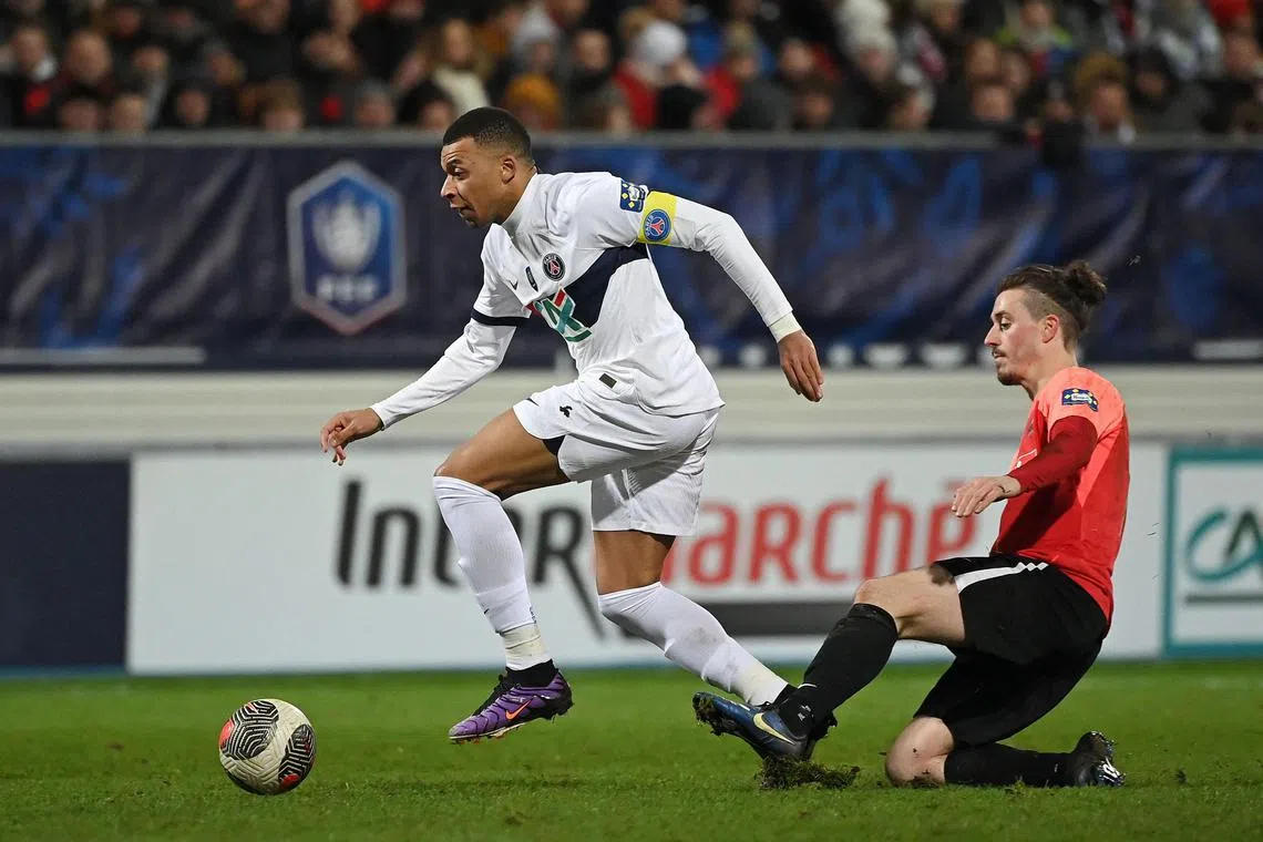 Paris Saint-Germain forward Kylian Mbappe dribbling past Revel's Pierre Ritter during the French Cup.