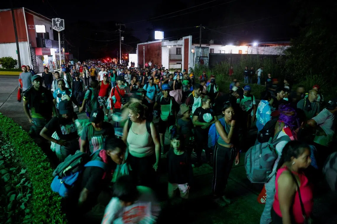 Migrants walk in a caravan after having rested on their way to the U.S. border, in Huixtla, Mexico November 7, 2024. REUTERS/Daniel Becerril