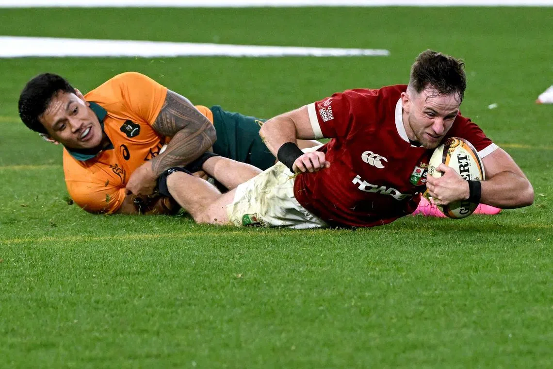 British and Irish Lions’ Hugo Keenan scoring the winning try despite being tackled by Australia’s Len Ikitau in the second rugby Test at the Melbourne Cricket Ground on July 26, 2025.