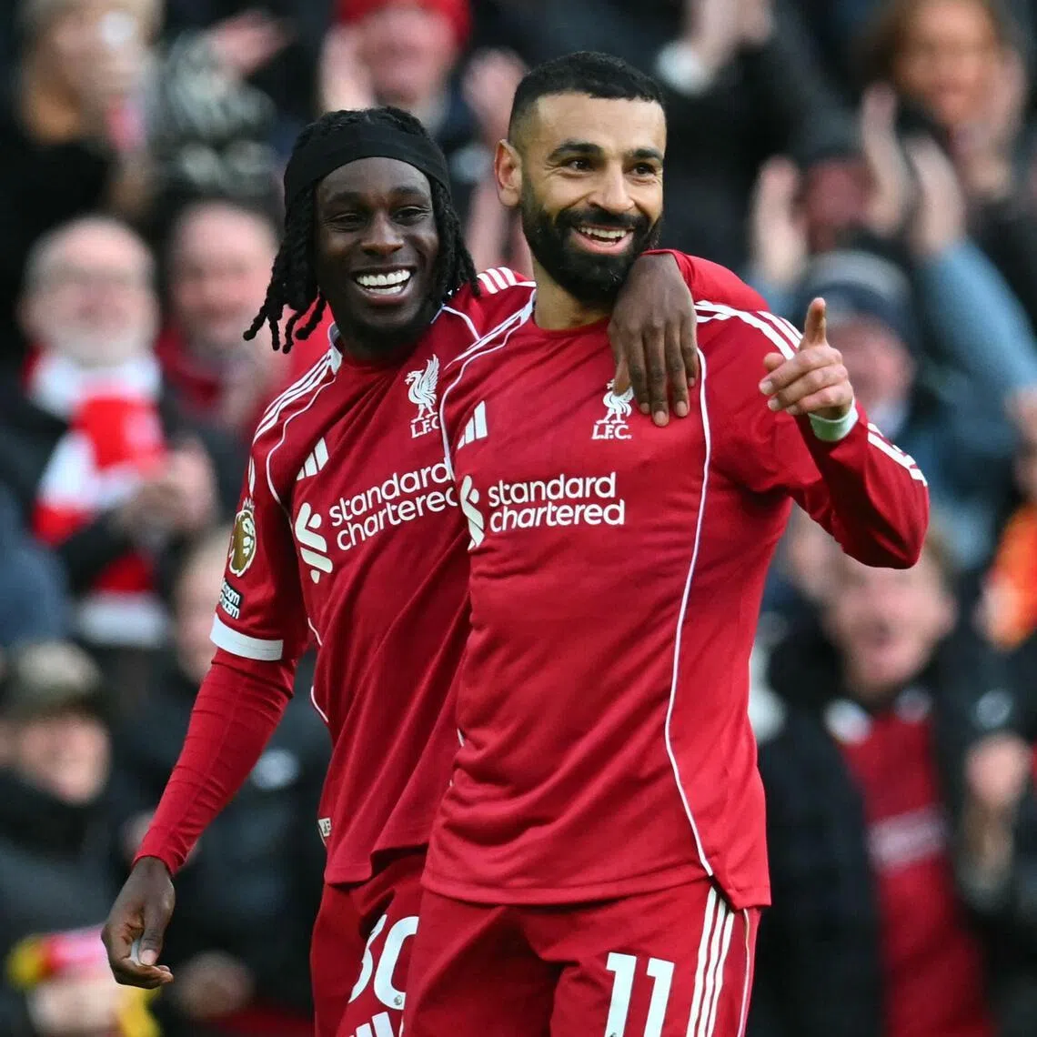 Liverpool's Mohamed Salah (right) celebrates with teammate Jeremie Frimpong after scoring their second goal against Fulham.