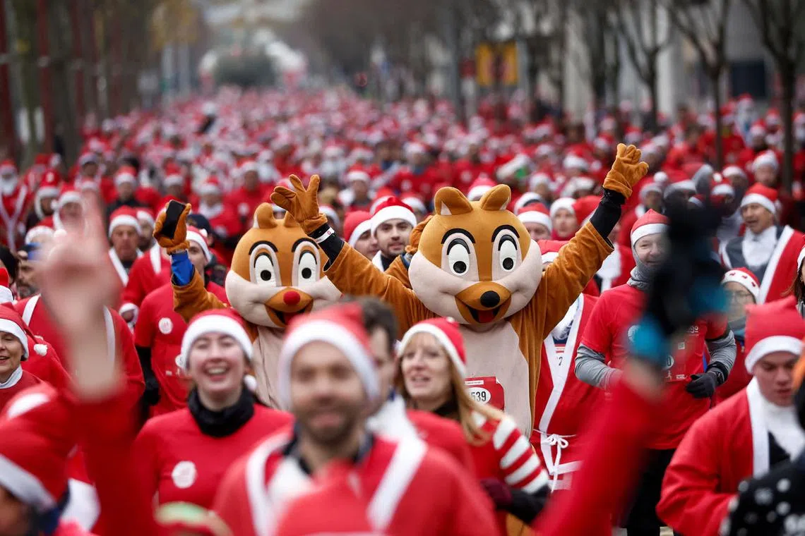 Runners dressed as Santa Claus take part in the Christmas Corrida Race on the streets of Issy-les-Moulineaux, near Paris, France, Dec 11, 2022. 