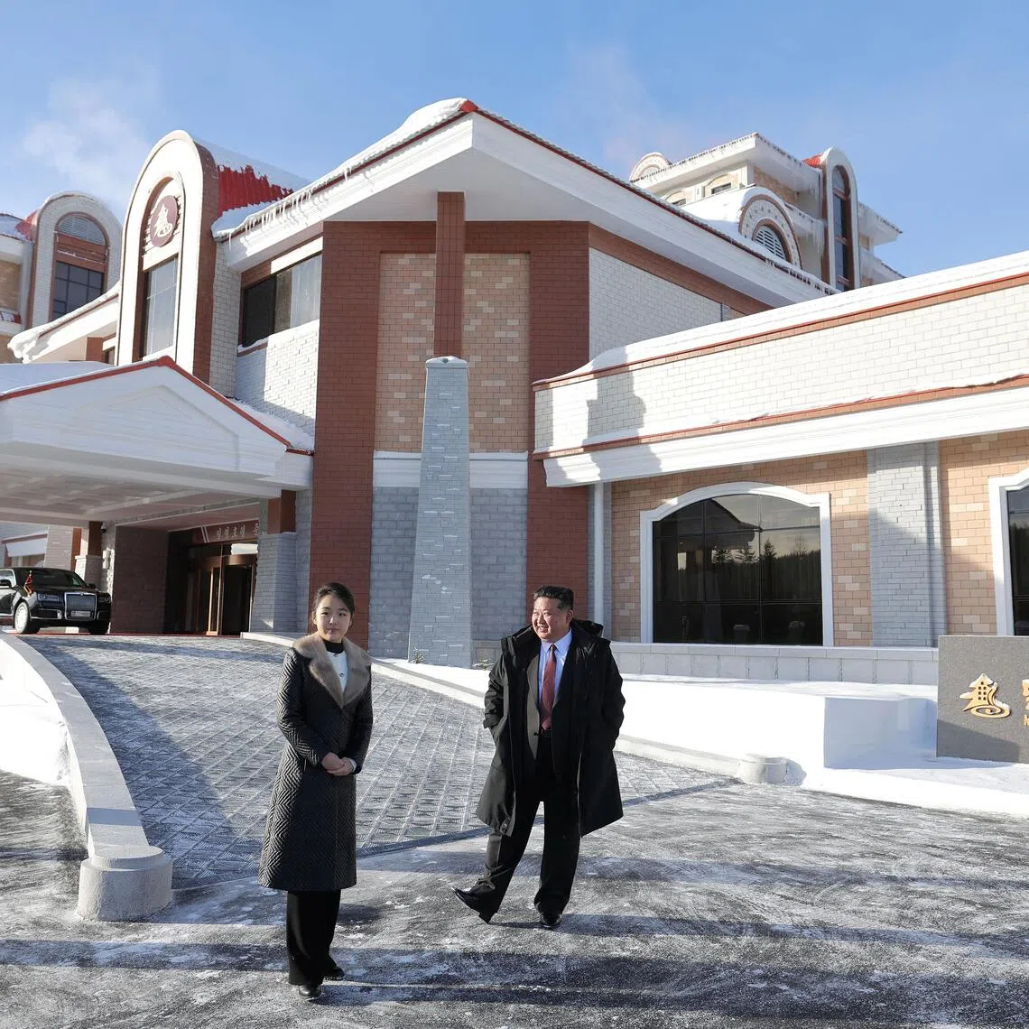 North Korean leader Kim Jong Un and his daughter Kim Ju Ae stand outside the Milyong Hotel as they attend an inauguration ceremony for hotels in the tourist resort in Samjiyon city, North Korea.