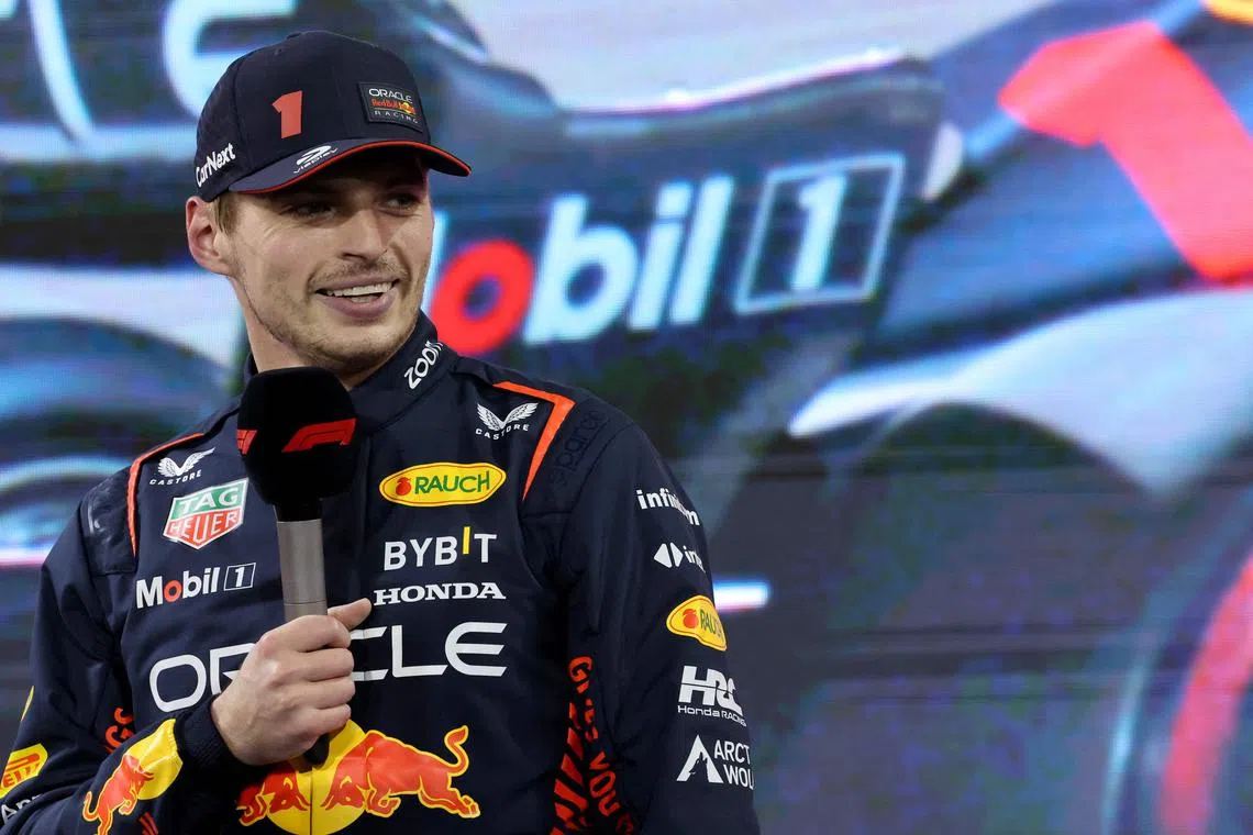 Red Bull's Max Verstappen speaks in the pit lane after qualifying in pole position for the Bahrain grand prix.