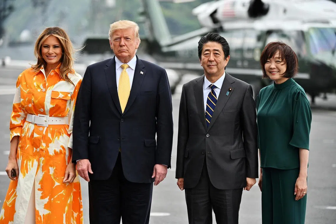US President-elect Donald Trump and his wife, Melania, met with then Japanese Premier Shinzo Abe and wife, Akie, in 2019.