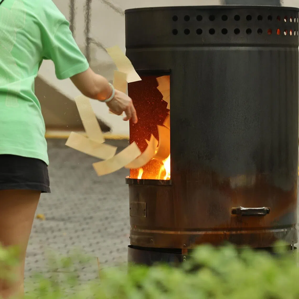 The process of burning joss paper produces smoke and ash.