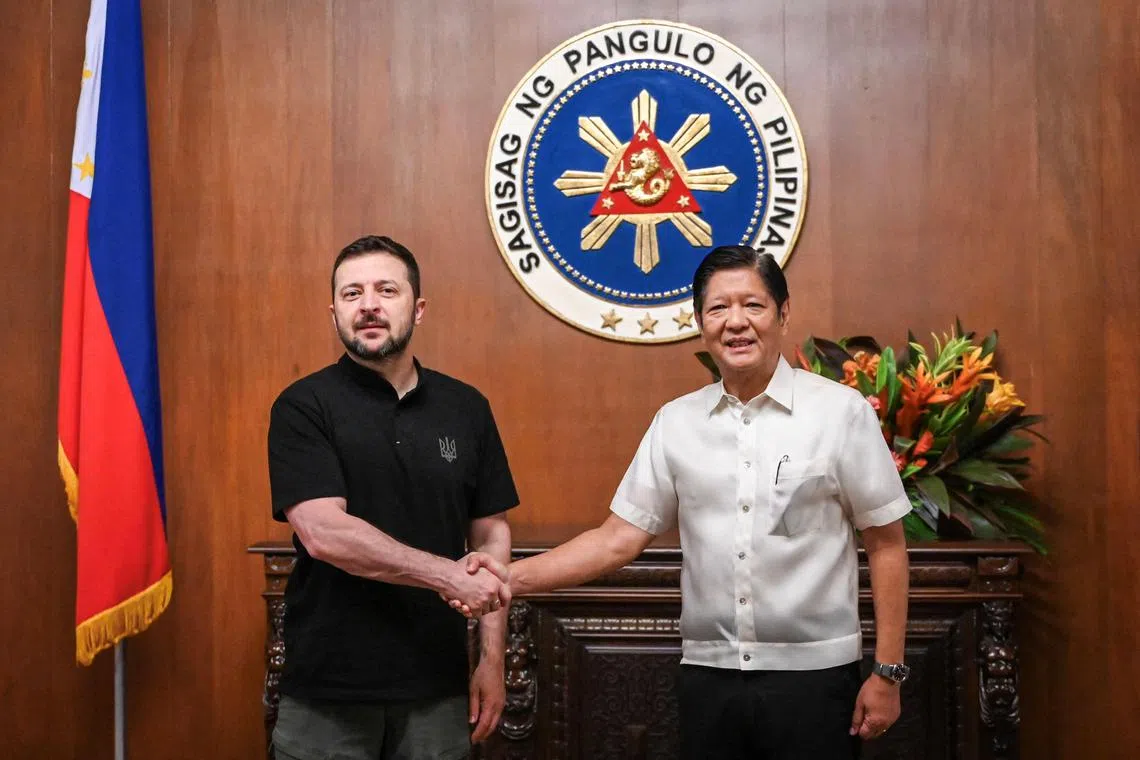 Philippines’ President Ferdinand Marcos Jr. (R) shakes hands with Ukraine’s President Volodymyr Zelensky (L) upon his arrival at the Malacanang Palace in Manila on June 3, 2024. (Photo by JAM STA ROSA / POOL / AFP)