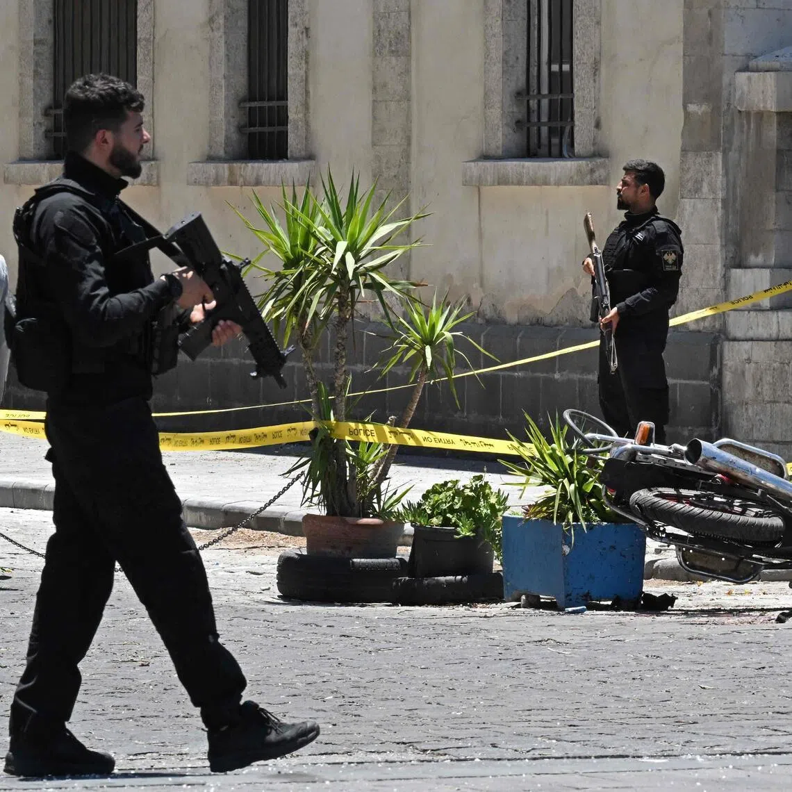 Security personnel standing guard near the Four Seasons Hotel, following two blasts nearby in Damascus on July 7, 2026.