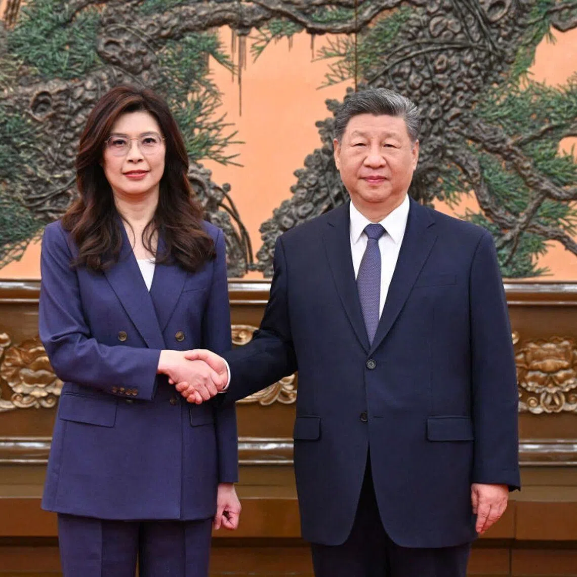 This is a handout photo taken and released on April 10, 2026, by the office of Kuomintang (KMT) shows Kuomintang Chairperson Cheng Li-wun (L) shaking hands with Chinese President Xi Jinping (R) at Great Hall of the People in Beijing. Xi told Cheng as the two met that "the general trend of compatriots on both sides of the Strait getting closer, edging nearer and becoming united will not change". (Photo by Handout / The Office of Kuomintang (KMT) lawmaker Johnny Chiang / AFP) / --- EDITORS NOTE --- RESTRICTED TO EDITORIAL USE - MANDATORY CREDIT "AFP PHOTO / The Office of Kuomintang (KMT)" - NO MARKETING NO ADVERTISING CAMPAIGNS - DISTRIBUTED AS A SERVICE TO CLIENTS - NO ARCHIVES