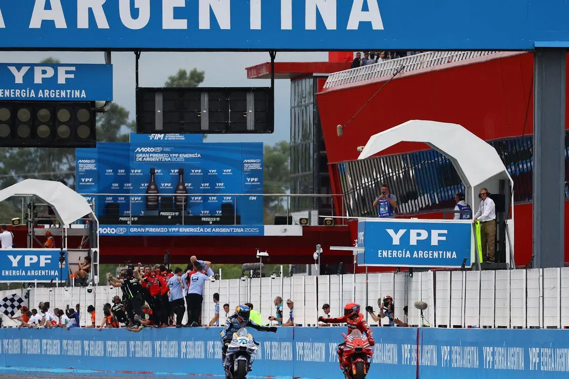 FILE PHOTO: MotoGP - Argentina Grand Prix - Autodromo Termas de Rio Hondo, Santiago del Estero, Argentina - March 16, 2025 Ducati Lenovo Team's Marc Marquez celebrates winning the race with second place BK8 Gresini Racing MotoGP's Alex Marquez REUTERS/Agustin Marcarian/File Photo