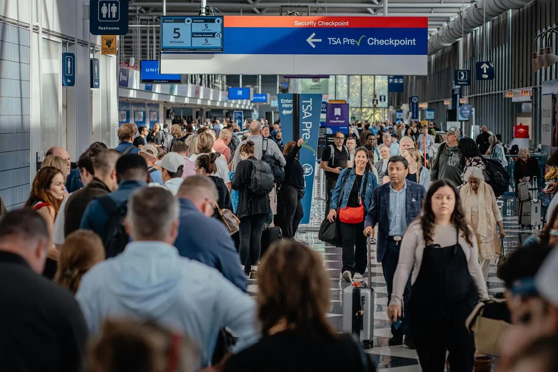 Passengers enter a security checkpoint at Chicago’s airport, as a US government shutdown reaches a record 40 days.
