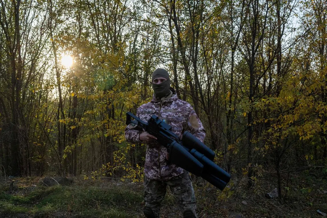 A Ukrainian soldier stands with an anti drone gun outside Mykolaiv, on November 2, 2022, amid the Russian invasion of Ukraine. (Photo by BULENT KILIC / AFP)