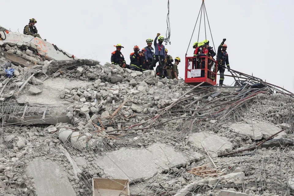 Rescue workers operate at the site of a collapsed building, following a strong earthquake in Bangkok on April 1.