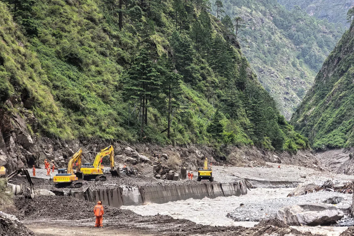 Rescue workers repair a damaged road leading to Gyirong Port following a mudslide on Aug 27.