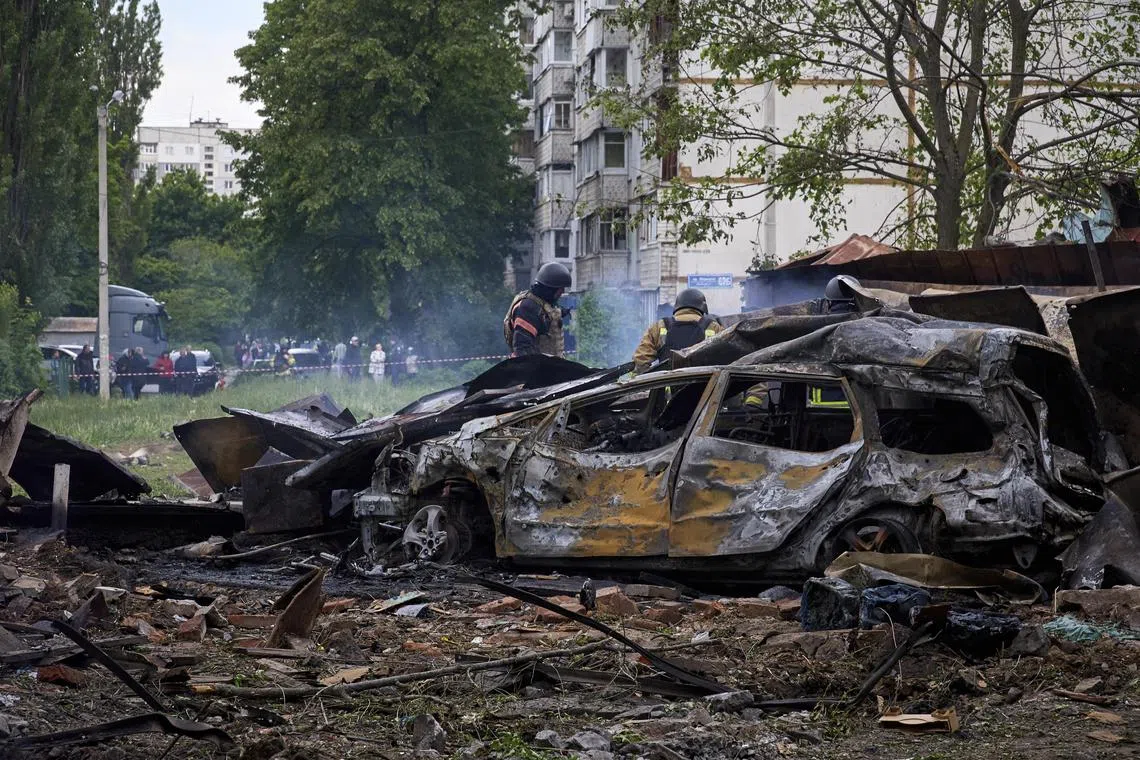 Rescue workers inspect a residential area in Kharkiv that was shelled on May 14 by advancing Russian troops.