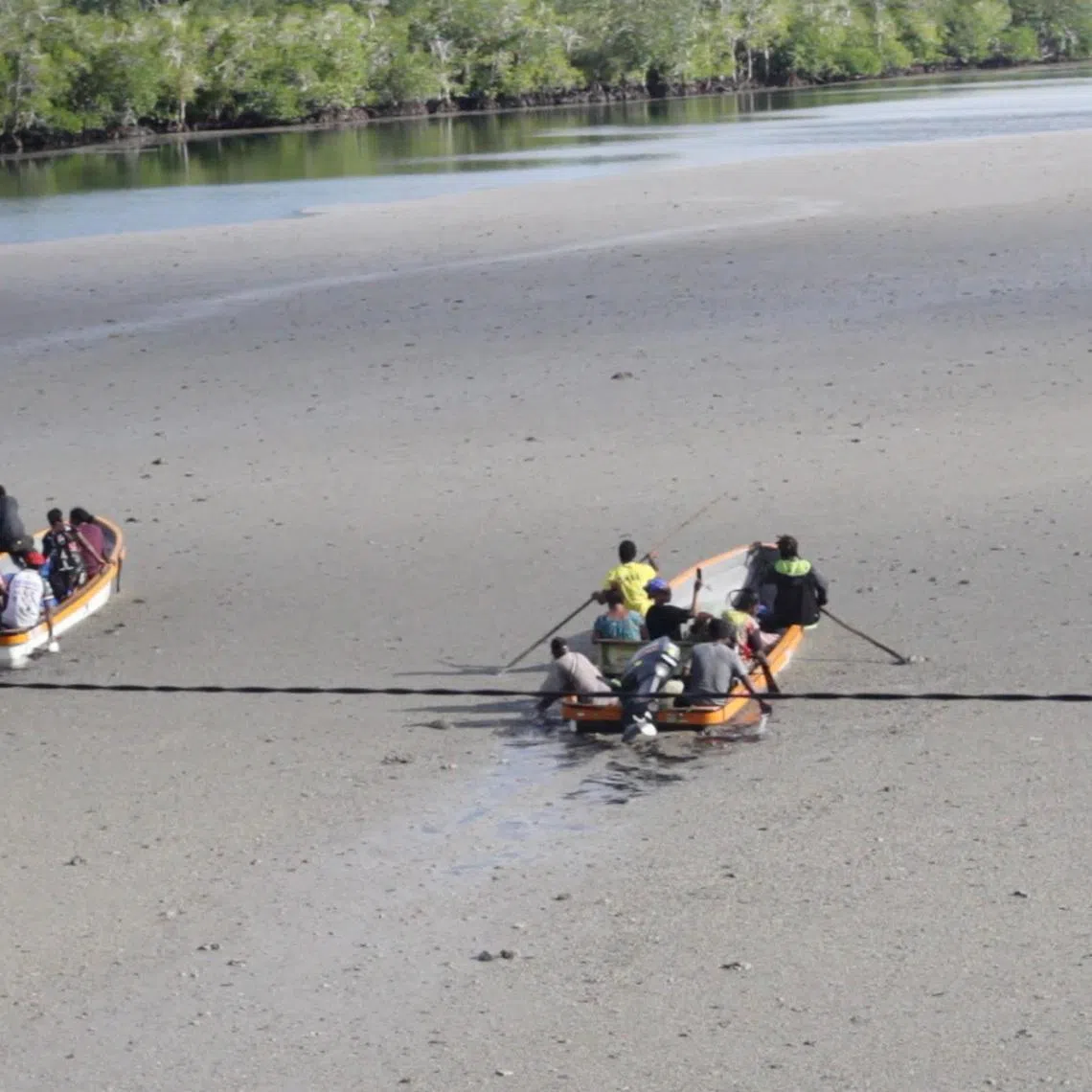 Locals raft through the pumice-covered Loniu Passage, following an undersea eruption, in Manus Province, Papua New Guinea, June 8, 2026, in this screengrab obtained from a social media video. Bellamy Popot/via REUTERS