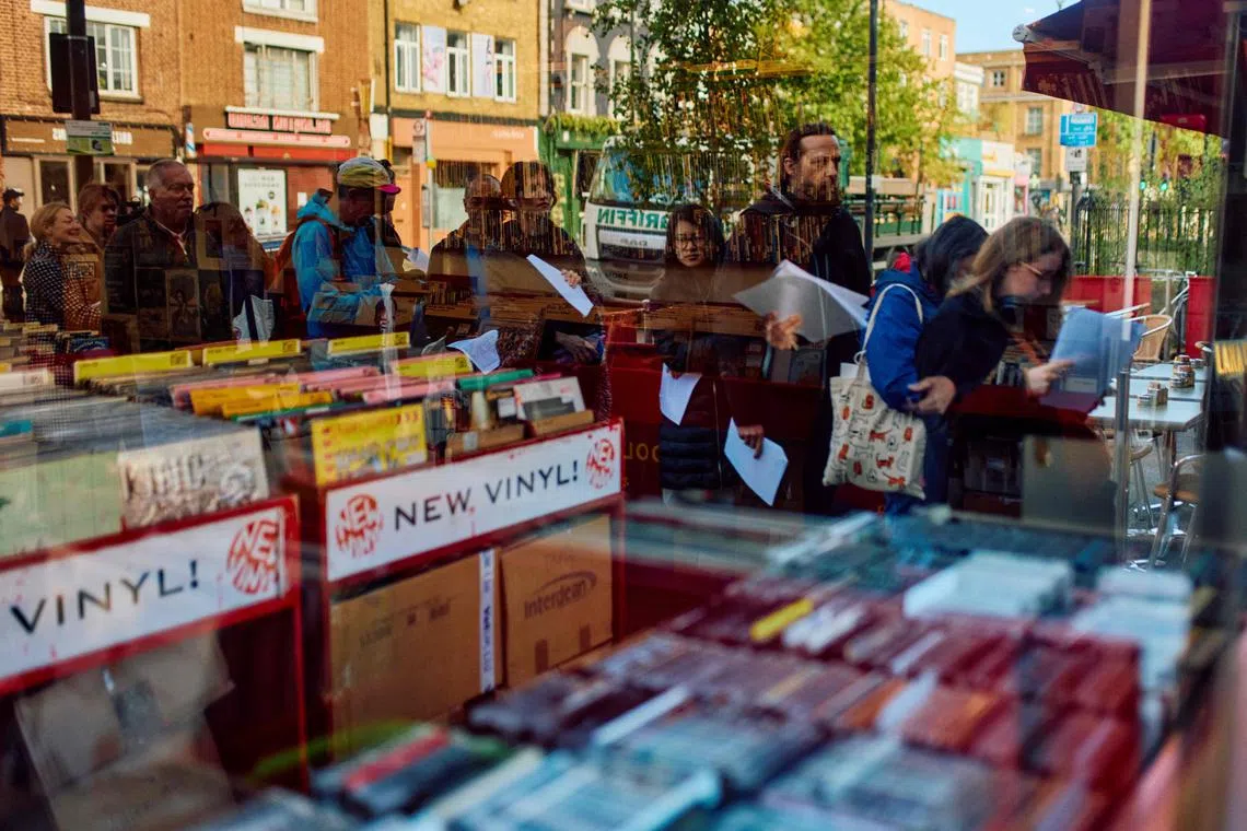 People queue outside indie record store Flashback Records to shop for vinyls on Record Store Day in London on April 20, 2024. (Photo by BENJAMIN CREMEL / AFP)