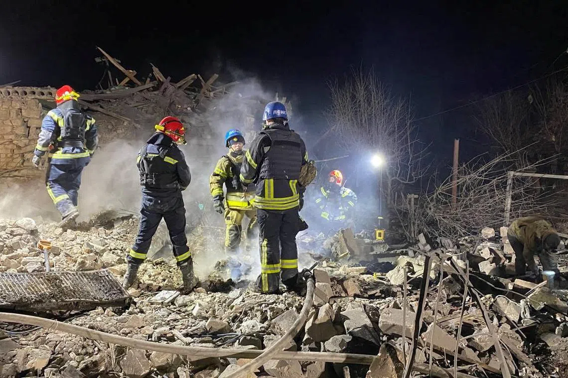 Rescuers work at the site of a Russian missile strike in Pokrovsk, in Ukraine's Donetsk region.