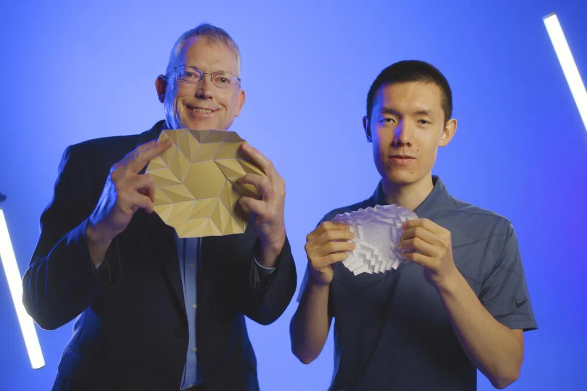 An undated photo provided by Brigham Young University shows, from left, Larry Howell, a professor of mechanical engineering at Brigham Young University and Kelvin Wang, a sophomore there. Researchers have now found a new class of origami that they call bloom patterns, which are rotationally symmetric around the center. (Brigham Young University via The New York Times) — NO SALES; FOR EDITORIAL USE ONLY WITH NYT STORY SLUGGED ORIGAMI PATTERN BY KENNETH CHANG FOR AUG. 19, 2025. ALL OTHER USE PROHIBITED. —