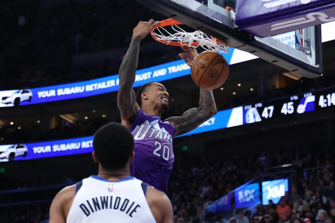 Utah Jazz forward John Collins dunks the ball against the Dallas Mavericks during the second quarter at Delta Centre.