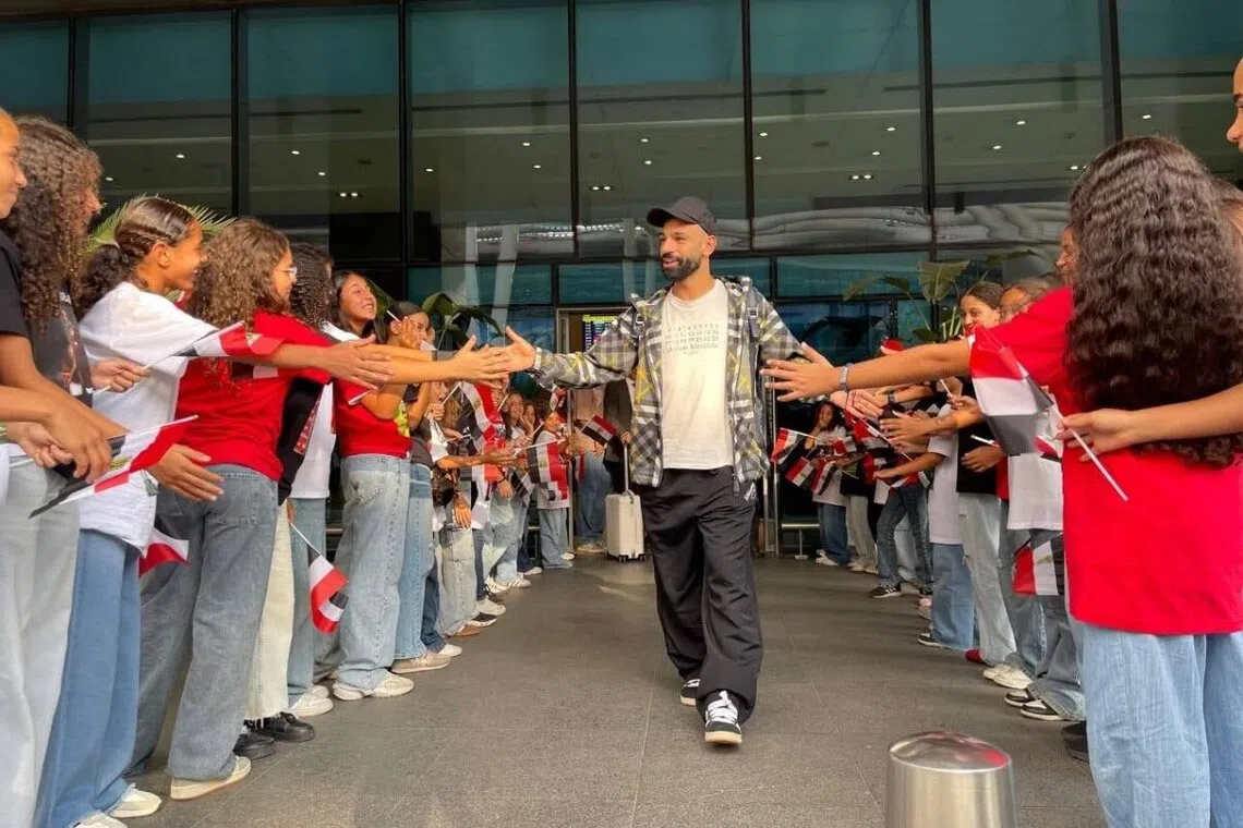 Liverpool forward Mohamed Salah receiving a hero’s welcome at the Cairo International Airport from fans in Cairo, Egypt, on Oct 5.