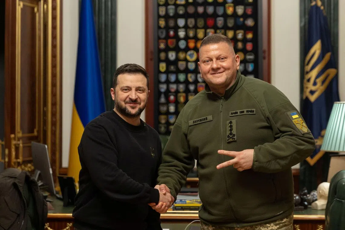 FILE PHOTO: Ukraine's President Volodymyr Zelenskiy and Commander in Chief of the Ukrainian Armed Forces Valerii Zaluzhnyi shake hand and pose for a picture during their meeting, amid Russia's attack on Ukraine, in Kyiv, Ukraine February 8, 2024. Ukrainian Presidential Press Service/Handout via REUTERS/File Photo