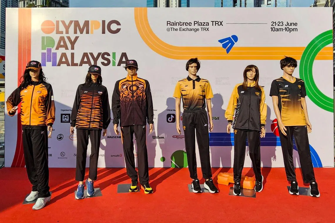 This picture taken on June 23, 2024 shows mannequins displaying the attire for Malaysia's athletes at the Paris 2024 Olympic Games during an event in Kuala Lumpur. Just do it. Yourself. That's the message Malaysia's Olympics chef de mission seems to be telling the fashion police as they lambast the nation's official attire design for the Paris Games. (Photo by AFP)