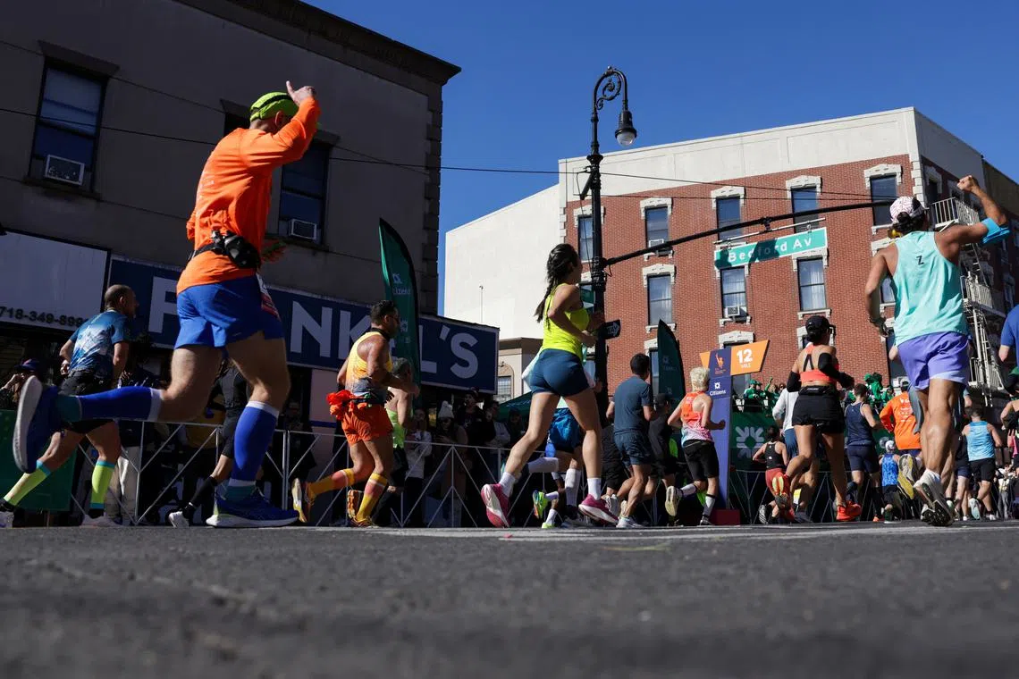 FILE PHOTO: Competitors run on Bedford Avenue through the Brooklyn borough during the 2024 TCS New York City Marathon, in New York City,  U.S., November 3, 2024. REUTERS/Kent J Edwards/File Photo