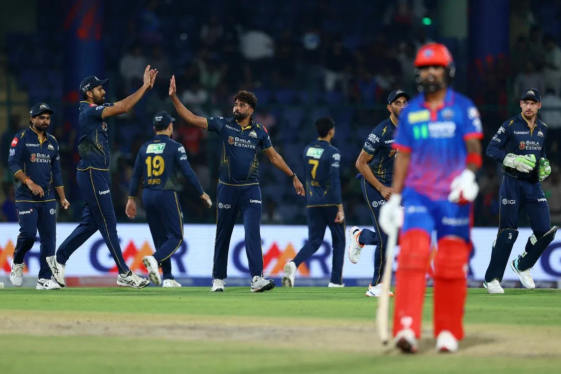 Cricket - Indian Premier League - IPL - Delhi Capitals v Gujarat Titans - Arun Jaitley Stadium, New Delhi, India - April 8, 2026 Gujarat Titans' Mohammed Siraj celebrates with teammates after taking the wicket of Delhi Capitals' KL Rahul, caught out by Jos Buttler REUTERS/Anushree Fadnavis