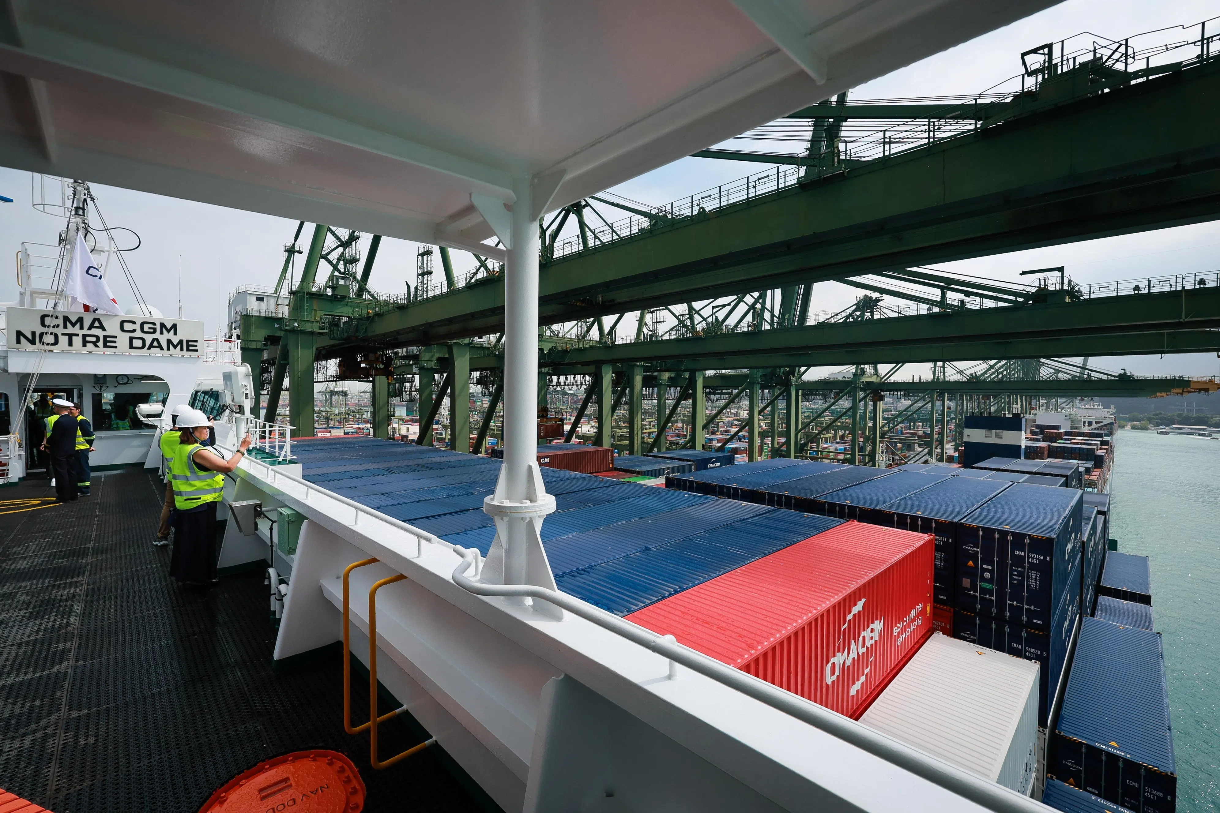 Guests taking pictures on the bridge wing during a tour of the CMA CGM Notre Dame berthed at Pasir Panjang Terminal on June 1.