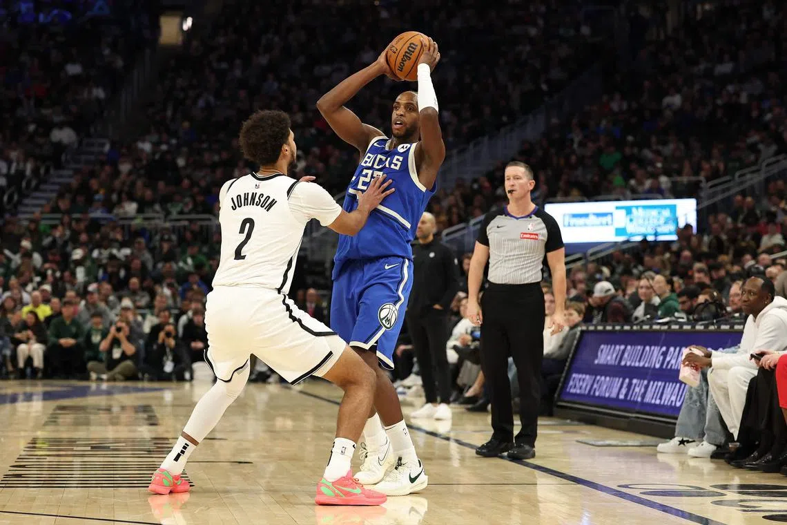 Khris Middleton of the Milwaukee Bucks is defended by Cameron Johnson of the Brooklyn Nets at Fiserv Forum on Dec 26, 2024.