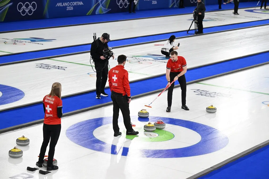 Milano Cortina 2026 Olympics - Curling - Mixed Doubles Round Robin Session 1 - Cortina Curling Olympic Stadium, Cortina d'Ampezzo, Italy - February 04, 2026 Yannick Schwaller of Switzerland and Briar Schwaller-Huerlimann of Switzerland in action during their mixed doubles round robin match against Marie Kaldvee of Estonia and Harri Lill of Estonia REUTERS/Jennifer Lorenzini