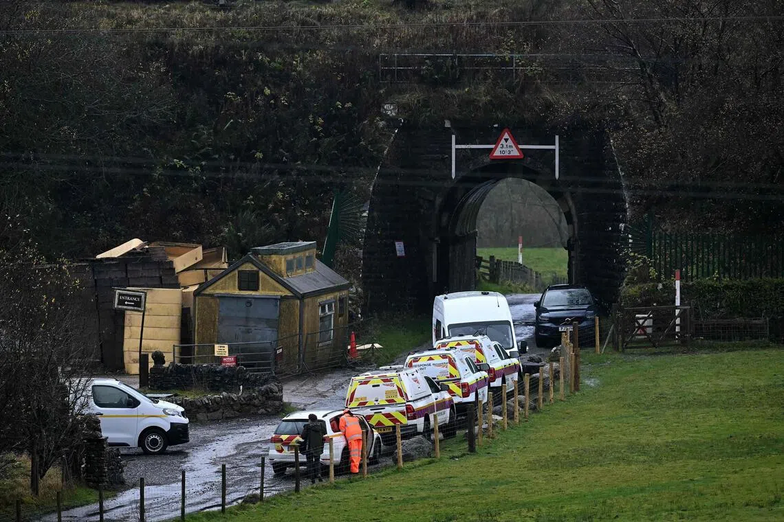 Vehicles belonging to Network Rail engineers are pictured close to where a train derailed in Britain's Cumbria region on Nov 3.