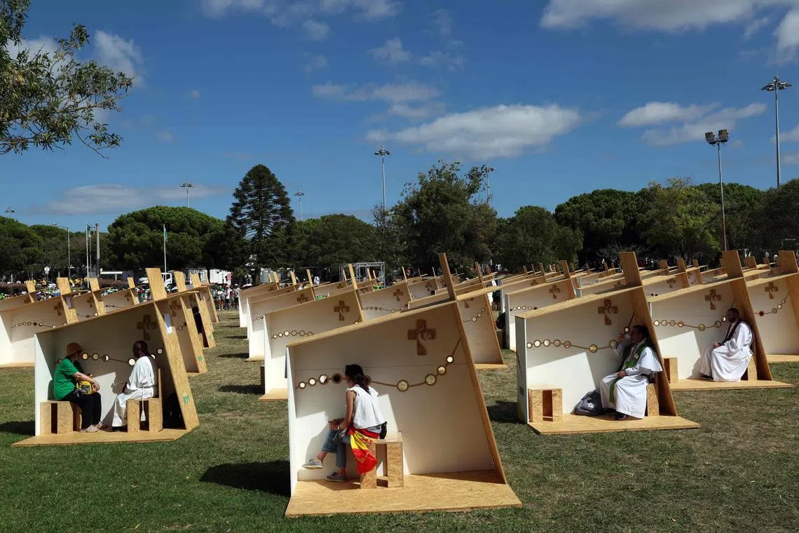 Pilgrims confessing in an open confessionals area in Belem, Lisbon, during the World Youth Day (WYD) celebration, on August 2, 2023. Pope Francis arrived in Lisbon today to gather with a million youngsters from across the world at the World Youth Day (WYD), held as the Church reflects on its future. The 86-year-old underwent major abdominal surgery just two months ago, but that has not stopped an event-packed 42nd trip abroad, with 11 speeches and around 20 meetings scheduled. 