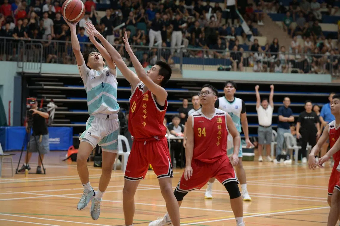 Hugo Tan (left) scores the game-winning layup with 4.3 seconds remaining.