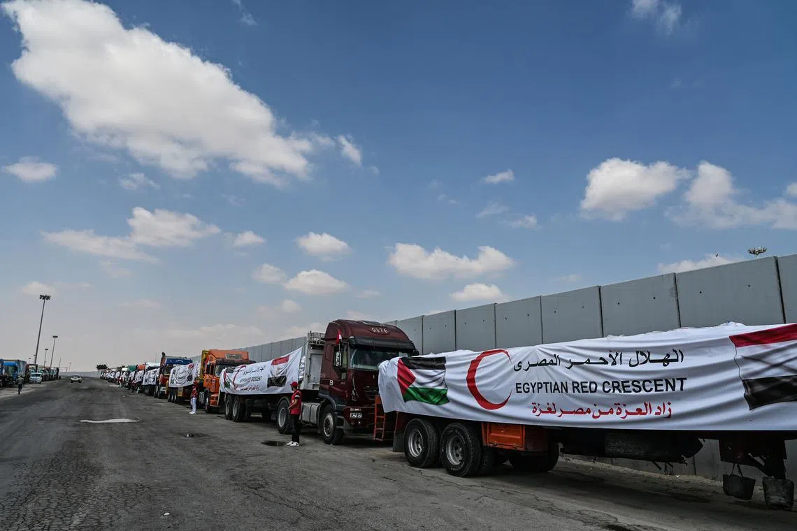 Trucks loaded with humanitarian aid bound for Gaza wait on the Egyptian side of the Rafah Border Crossing on Aug 18.