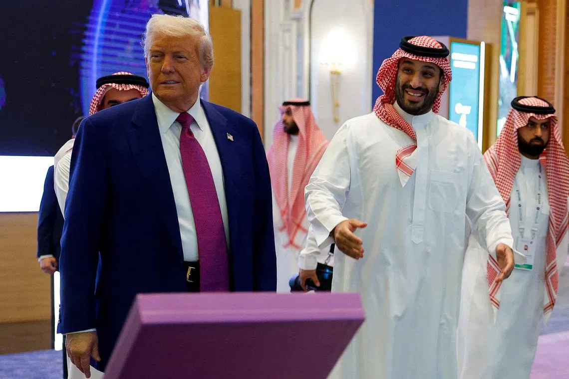 Saudi Crown Prince Mohammed Bin Salman reacts next to U.S. President Donald Trump during the Saudi-U.S. Investment Forum, in Riyadh, Saudi Arabia, May 13, 2025. REUTERS/Brian Snyder