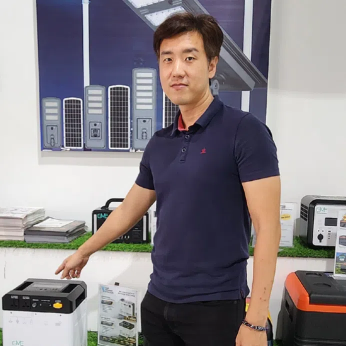 Mr Macsonn Chew (left), who sells portable power stations and solar systems for homes, and content creator Muhamad Saiful Khalib with one of his best-selling items, a hand-crank dynamo lamp.