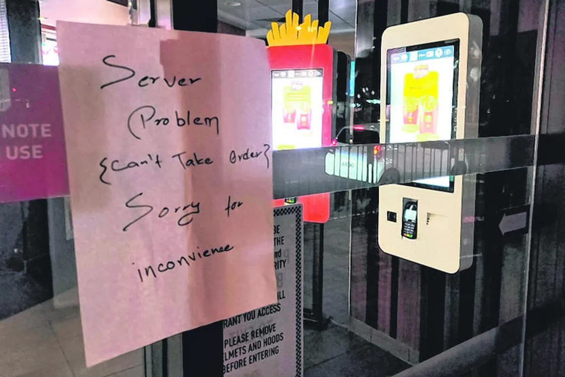 A sign adorns the entrance to a McDonald's restaurant in the Sydney suburb of Maroubra on March 15. Hungry McDonald's customers had trouble ordering at stores, on cellphones and at electronic kiosks after a system outage.