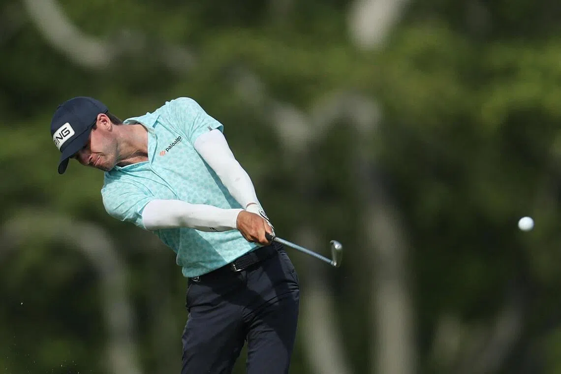 Alex Smalley of the United States hitting an approach shot on the 10th hole during the third round of the PGA Championship at Aronimink Golf Club on May 16.