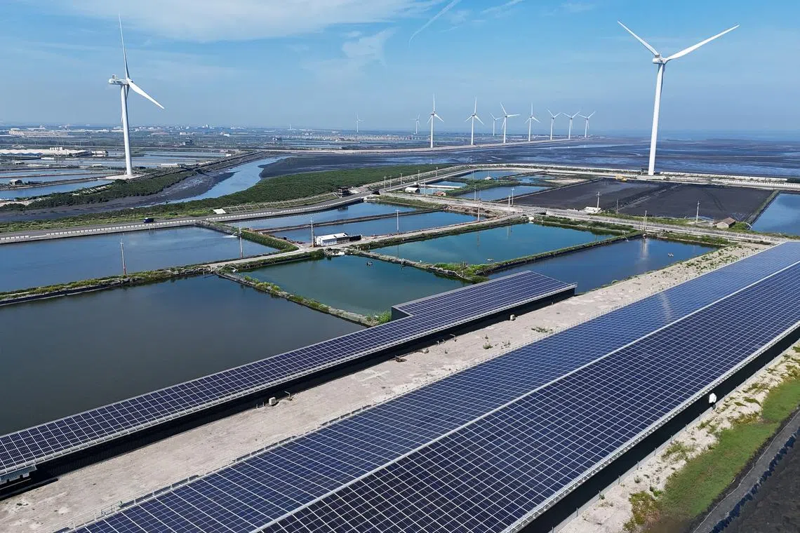 A drone image shows wind turbines and solar panels, in Changhua, Taiwan, May 16, 2025. REUTERS/Ann Wang/File Photo