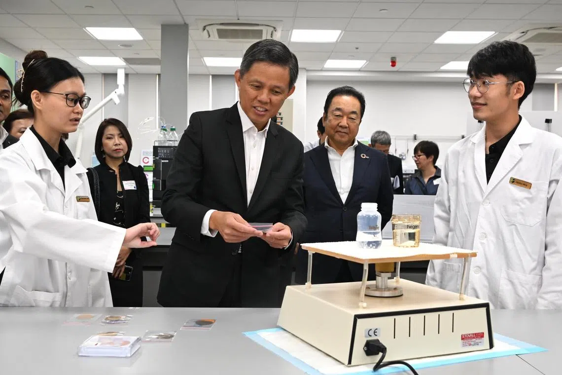Education Minister Chan Chun Sing (centre) on a tour of the Sustainable Technology & Analytical Research Laboratory at Republic Polytechnic on Jan 6, 2023.