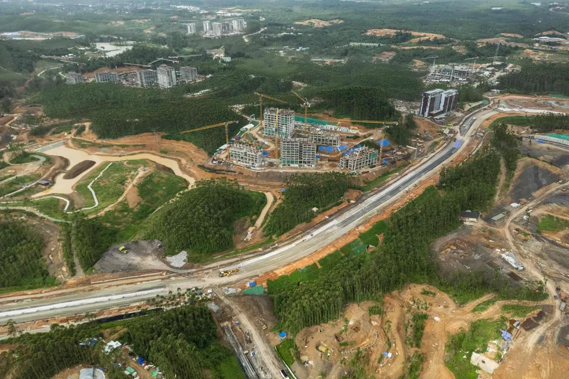 This picture taken on July 11, 2024 shows an aerial view of under construction buildings at the future Capital City of Nusantara in Penajam Paser Utara, East Kalimantan. It was supposed to be the jewel in the crown of the 10-year presidency of Joko Widodo, but Indonesia's capital-to-be, carved out of dense jungle in Borneo, is a vast building site just weeks before being due to open. Bar the centrepiece presidential palace -- winged like the national emblem, the mythical Garuda bird -- Nusantara is a series of unfinished buildings and bumpy access tracks, shrouded by clouds of dust kicked up by trucks and excavators. (Photo by AFP) / To go with 'INDONESIA-CAPITAL-ENVIRONMENT, FOCUS' by Jack Moore with Marchio Gorbiano in Jakarta