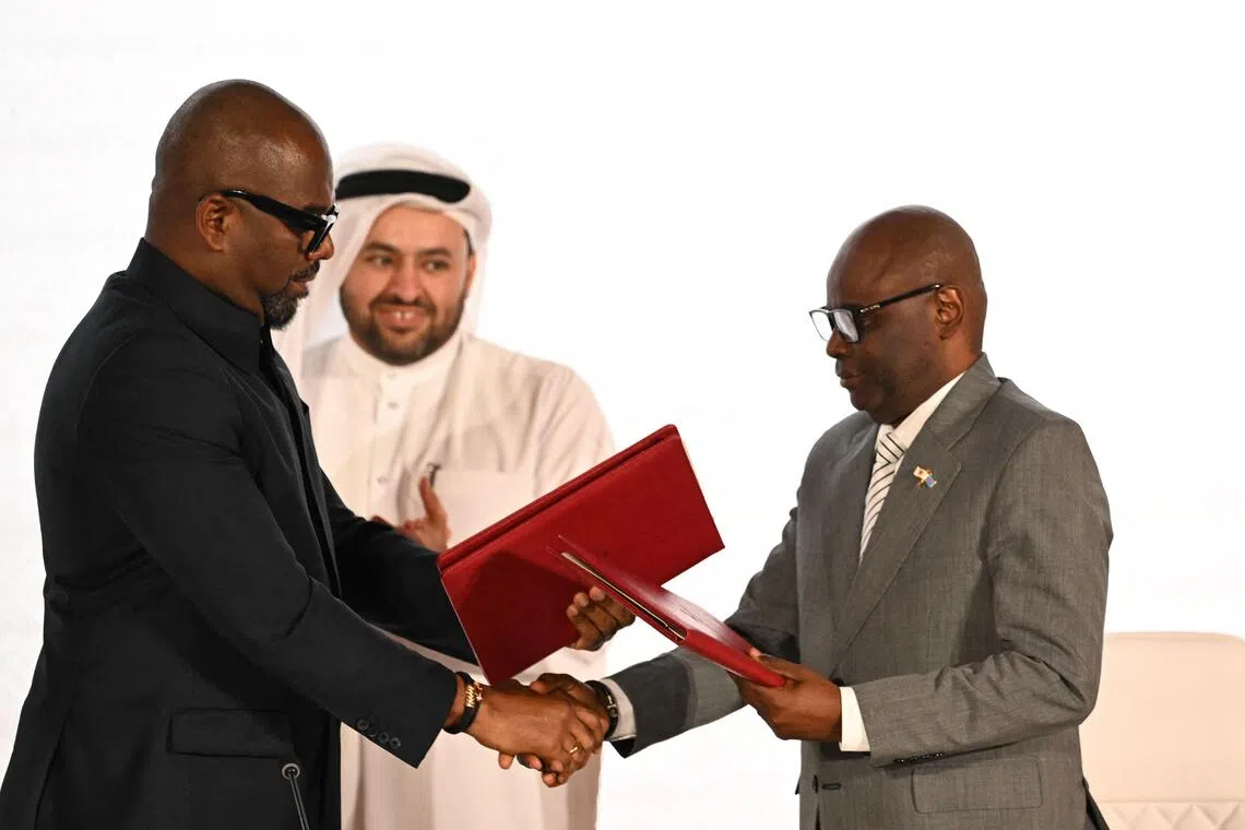 Representatives for the Democratic Republic of Congo (left) and and Rwanda-backed armed group M23 shaking hands at the peace signing ceremony in Doha, on Nov 15.