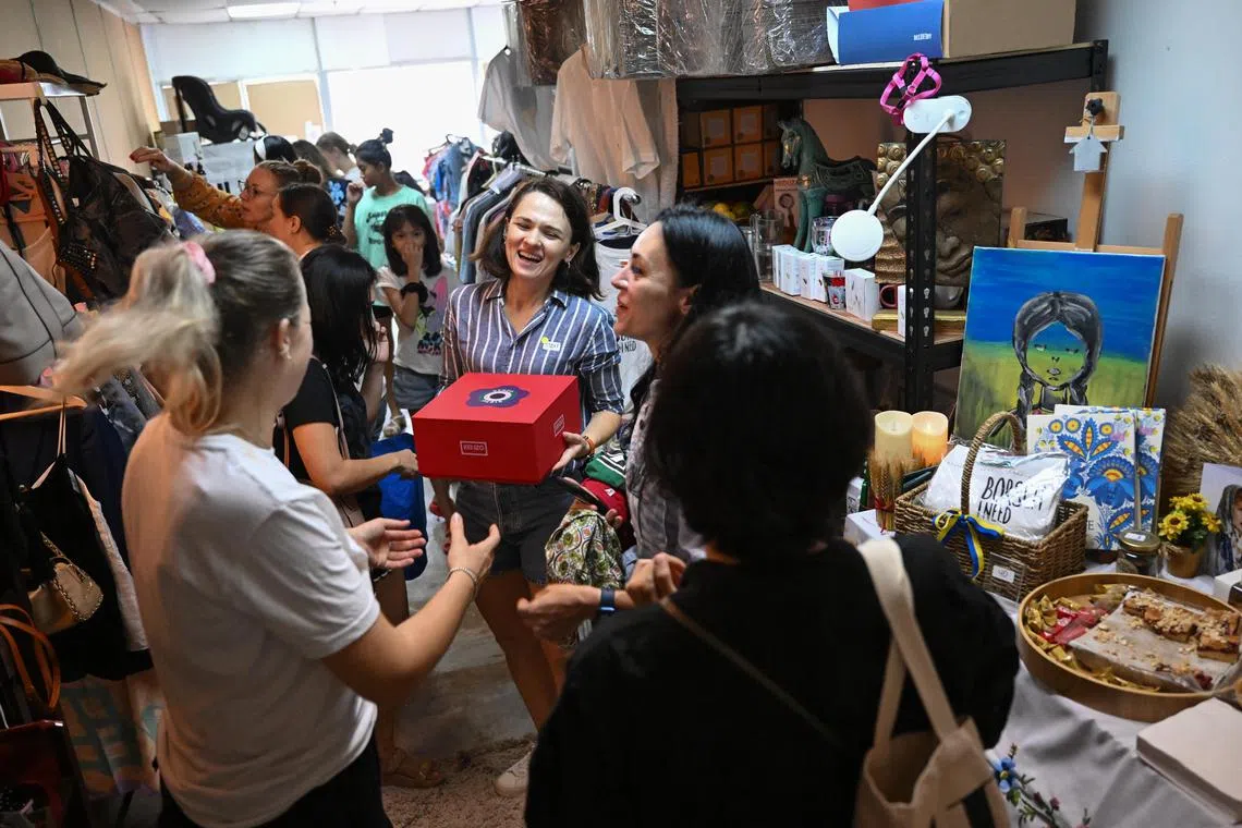 ST20230923_202311275968/Shintaro Tay/ A group of some 20 Ukrainians living in Singapore came together on Saturday to organise a garage sale to raise funds for the armed conflict in Ukraine. The event is co-organised by 37-year-old Olesya Lyashevich at a warehouse at Da Lin Factory Building in Paya Lebar Road. Clothes, shoes, books and household appliances are some of the items sold for as low as 50 cents. There is also a corner for free Items as the team also aims at promoting sustainability. Some Singaporeans responded to the social media call for donation such as 29-year-old Andrew Tan, who brought two new branded shoes and some clothes to donate. Visitors are welcomed to the venue with a glass of Prosecco and some food like crepes. The event carries on till 8pm today, and will end on Sunday.