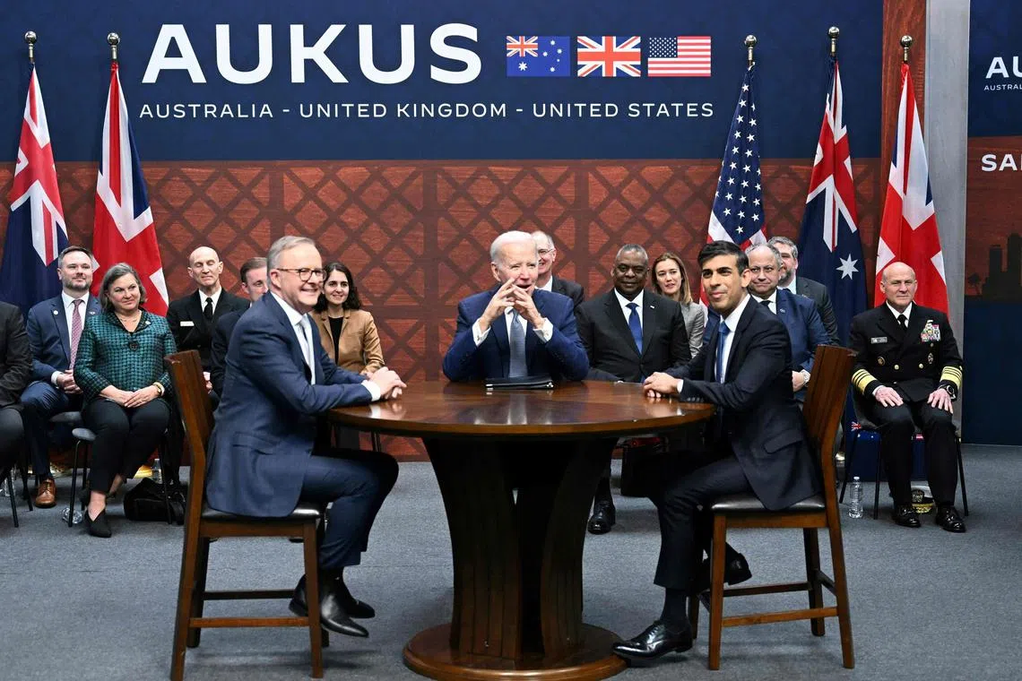 US President Joe Biden (C) participates in a trilateral meeting with British Prime Minister Rishi Sunak (R) and Australia's Prime Minister Anthony Albanese (L) during the AUKUS summit on March 13, 2023, at Naval Base Point Loma in San Diego California. - AUKUS is a trilateral security pact announced on September 15, 2021, for the Indo-Pacific region. (Photo by Jim WATSON / AFP)