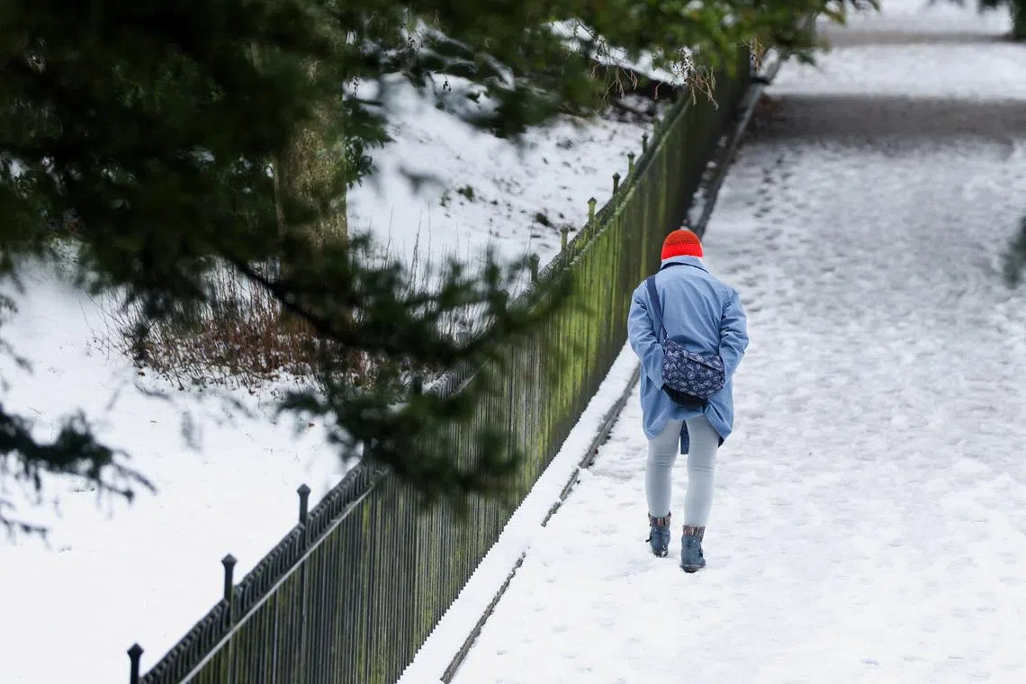 A person walks along a snow-covered path, after Storm Goretti's arrival amid a week of plunging temperatures, in Buxton, Britain, January 9, 2026. REUTERS/Temilade Adelaja